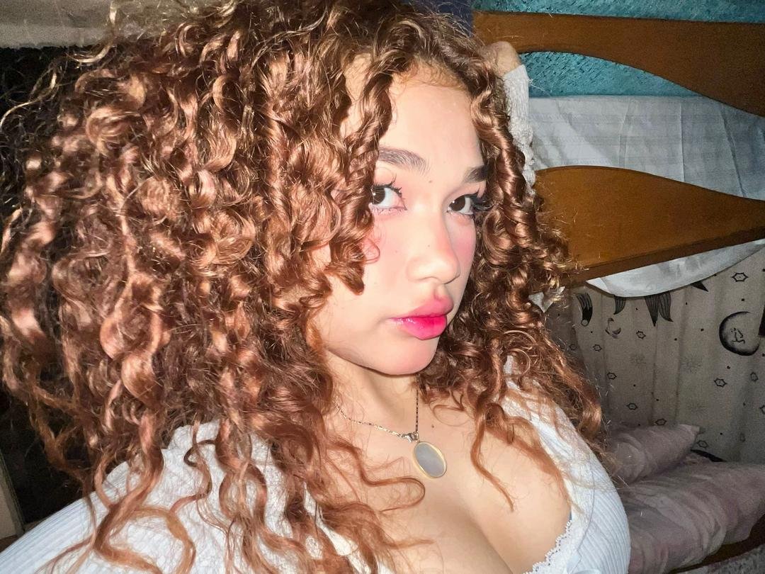 Naughty Asian Redhead Showing Off That Tight Curly Hair and Body 1